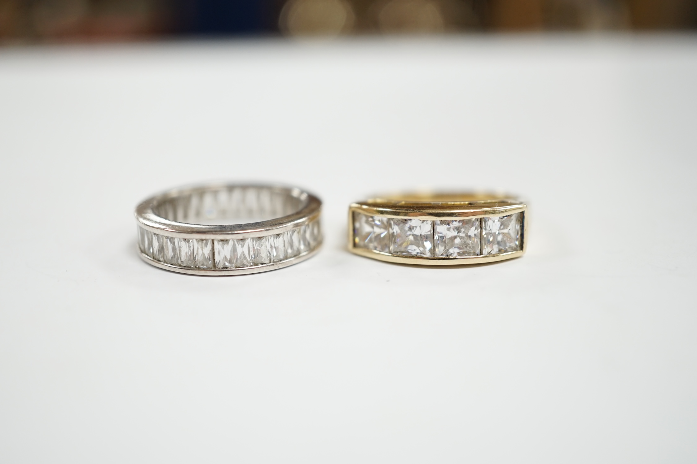 A 9k and simulated diamond set half hoop ring and a 925 and simulated diamond set eternity ring.